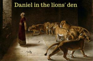Daniel standing in a stone den surrounded by several lions, with the caption "Daniel in the lions' den."