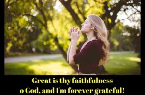 person standing outdoors on grass with trees behind, hands clasped together in prayer or gratitude, wearing a dark dress and necklace, accompanied by the words: 'Great is thy faithfulness o God, and I'm forever grateful!'